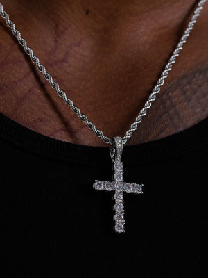 Close view of the silver stone set cross pendant showing the setting and bail