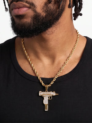 Man wearing the gold filled uzi pendant on a 6mm rope chain with a black vest
