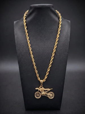 Gold filled bike pendant on a 6mm rope chain displayed on a black bust