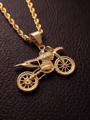 Close up of the gold filled dirt bike pendant with stone set detailing