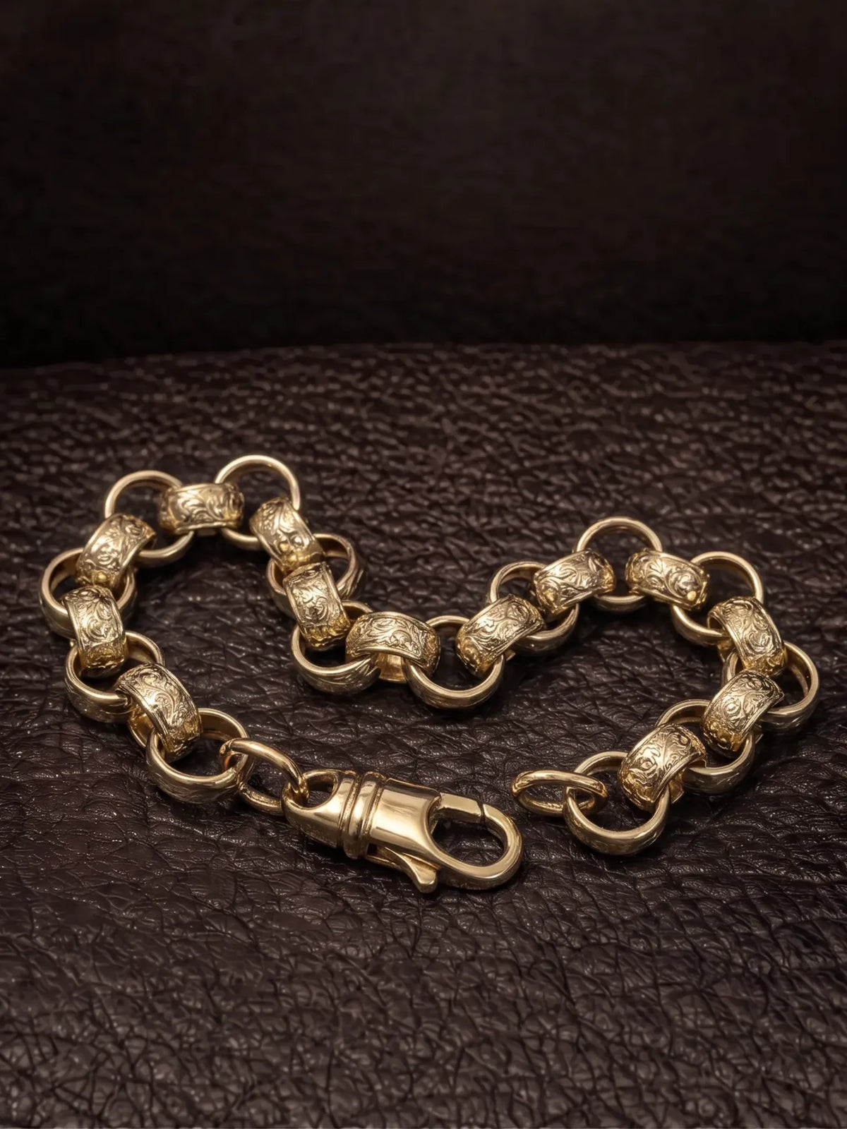 Side view of the 15mm patterned belcher bracelet showing the engraved links and lobster clasp