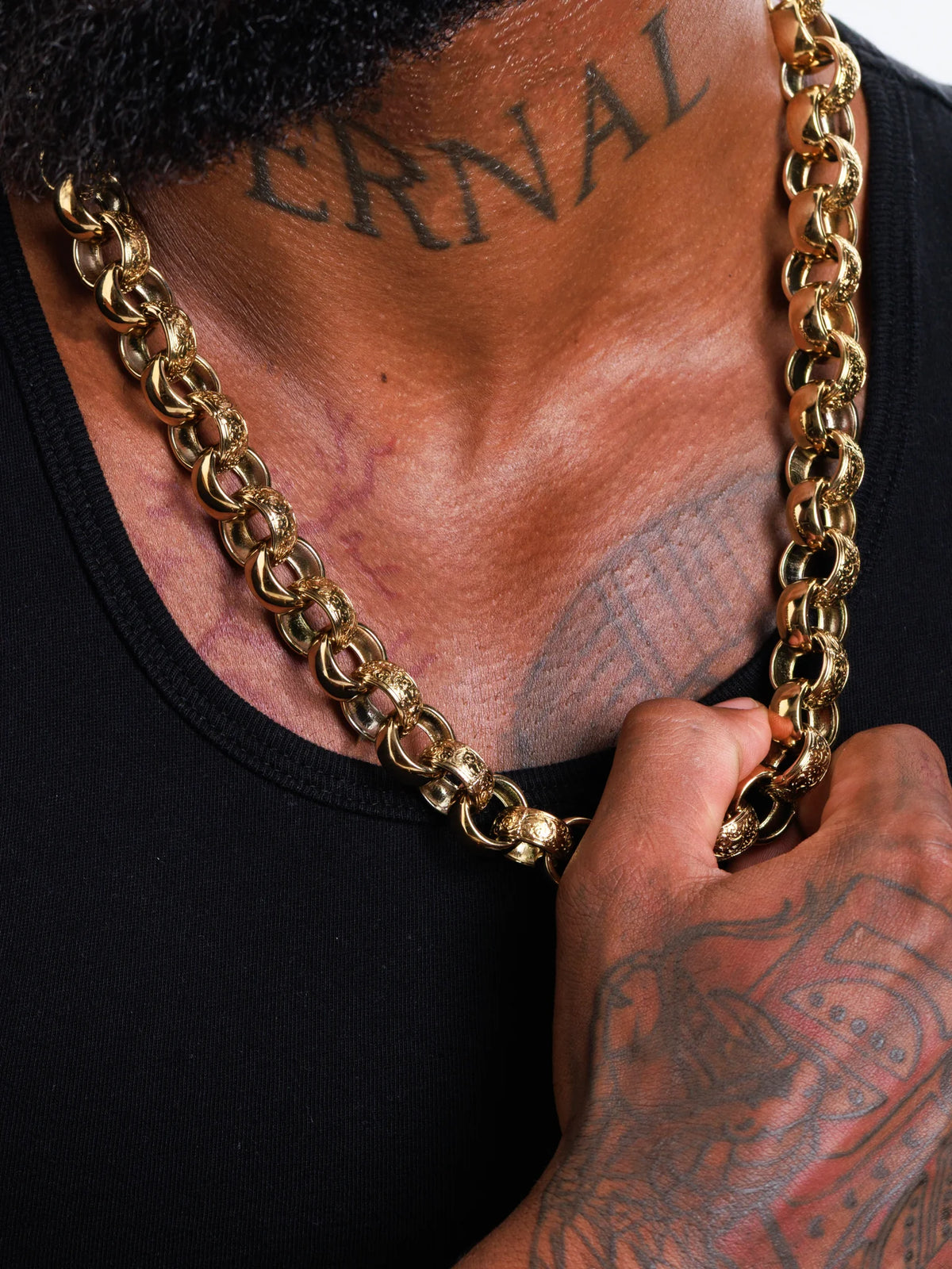The 15mm patterned belcher chain held in hand showing the weight of the links