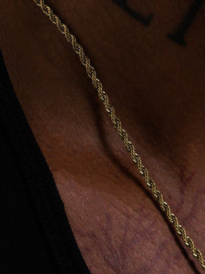 Macro detail of the 3mm gold rope chain showing the braided links