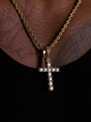 Close view of the stone set cross pendant showing the setting and bail