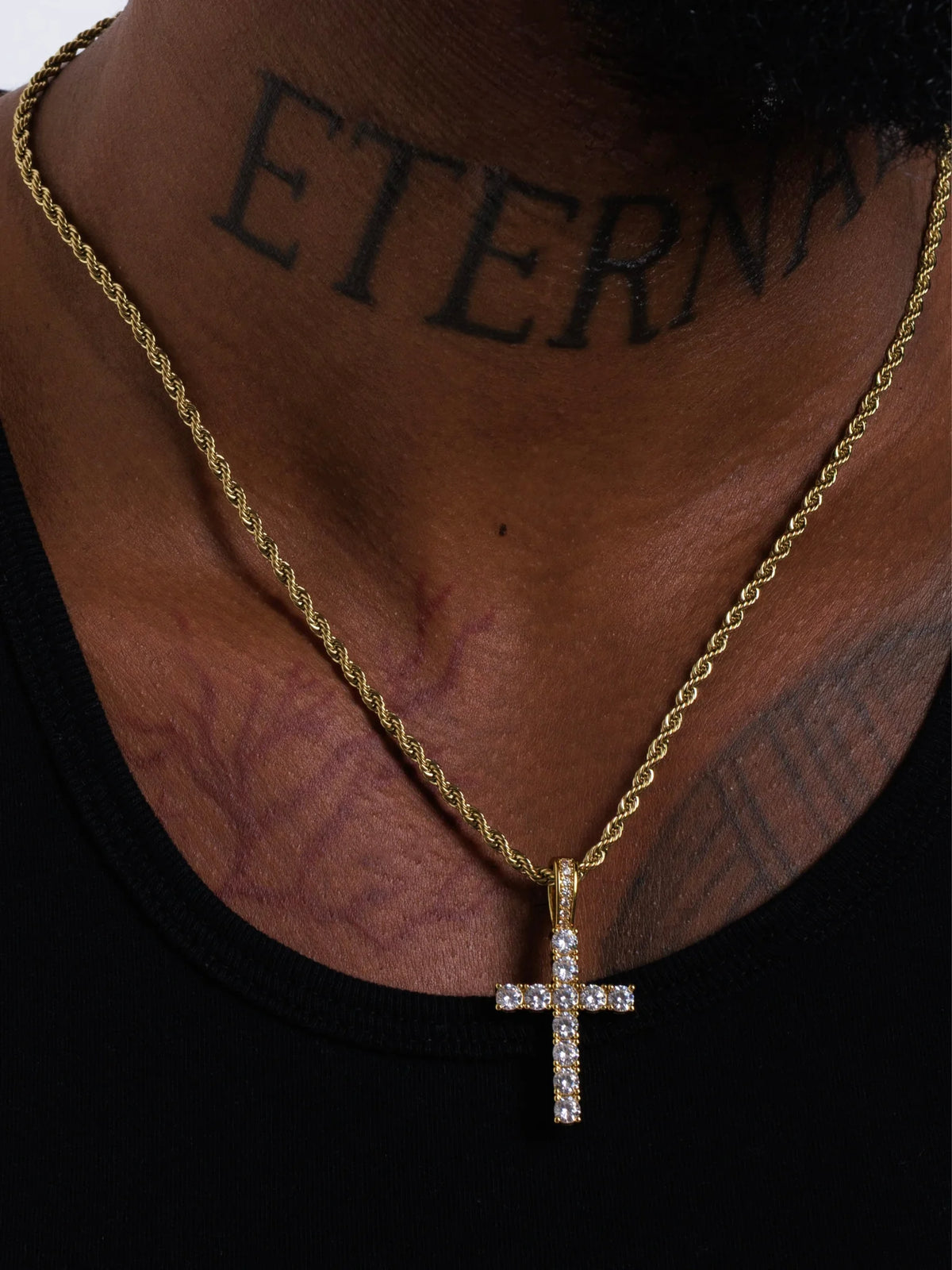 Cross pendant on a 3mm rope chain sitting mid chest at the 20 inch length