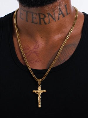 Gold filled INRI crucifix pendant on a 4mm Franco chain worn by a model in a black vest