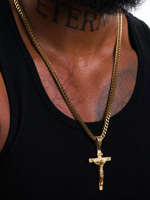 Gold filled crucifix pendant on a 4mm Franco chain layered with a second gold chain on a model