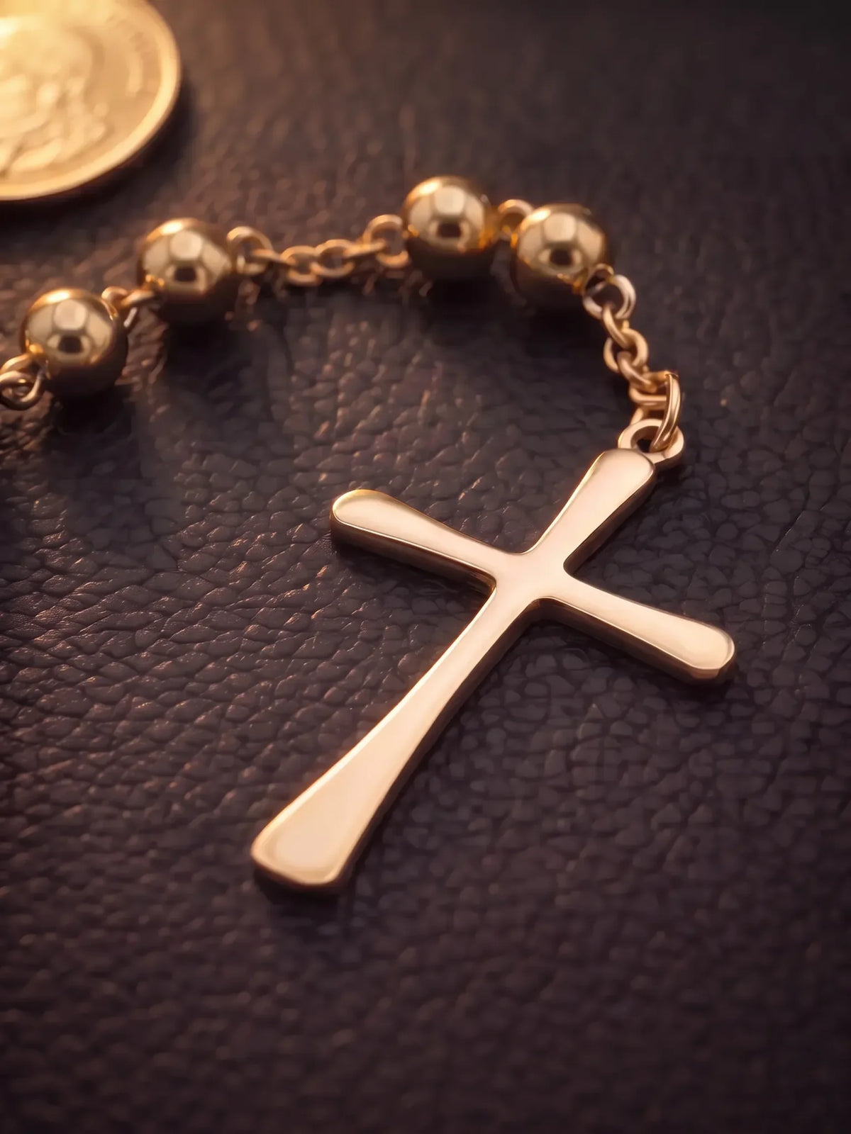 Close detail of the cross and beads on the gold filled rosary bead necklace