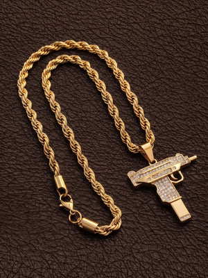 Gold filled uzi pendant on a 6mm rope chain laid out on dark leather with the clasp visible