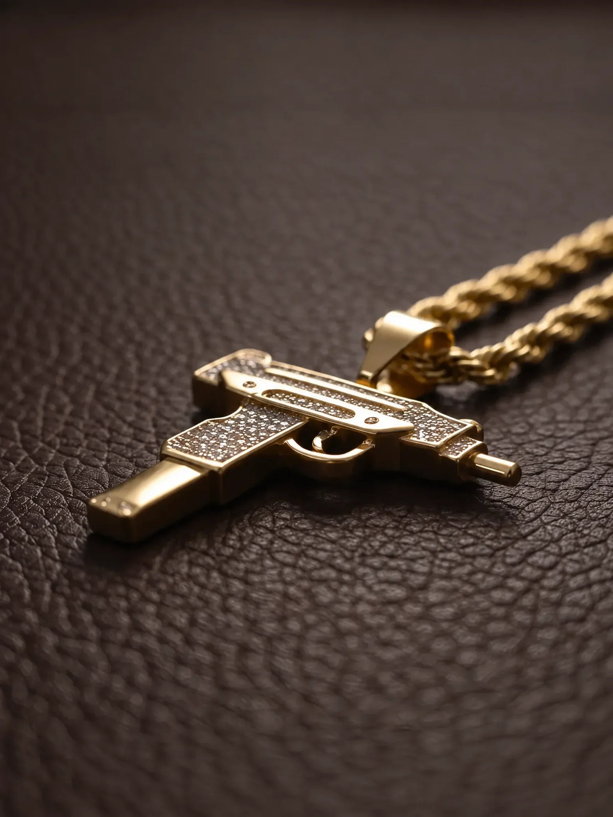 Angled view of the stone set uzi pendant beside the 6mm rope chain