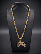 Gold filled bike pendant on a 6mm rope chain displayed on a black bust