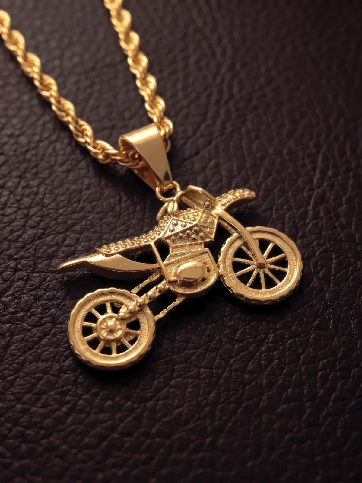 Close up of the gold filled dirt bike pendant with stone set detailing