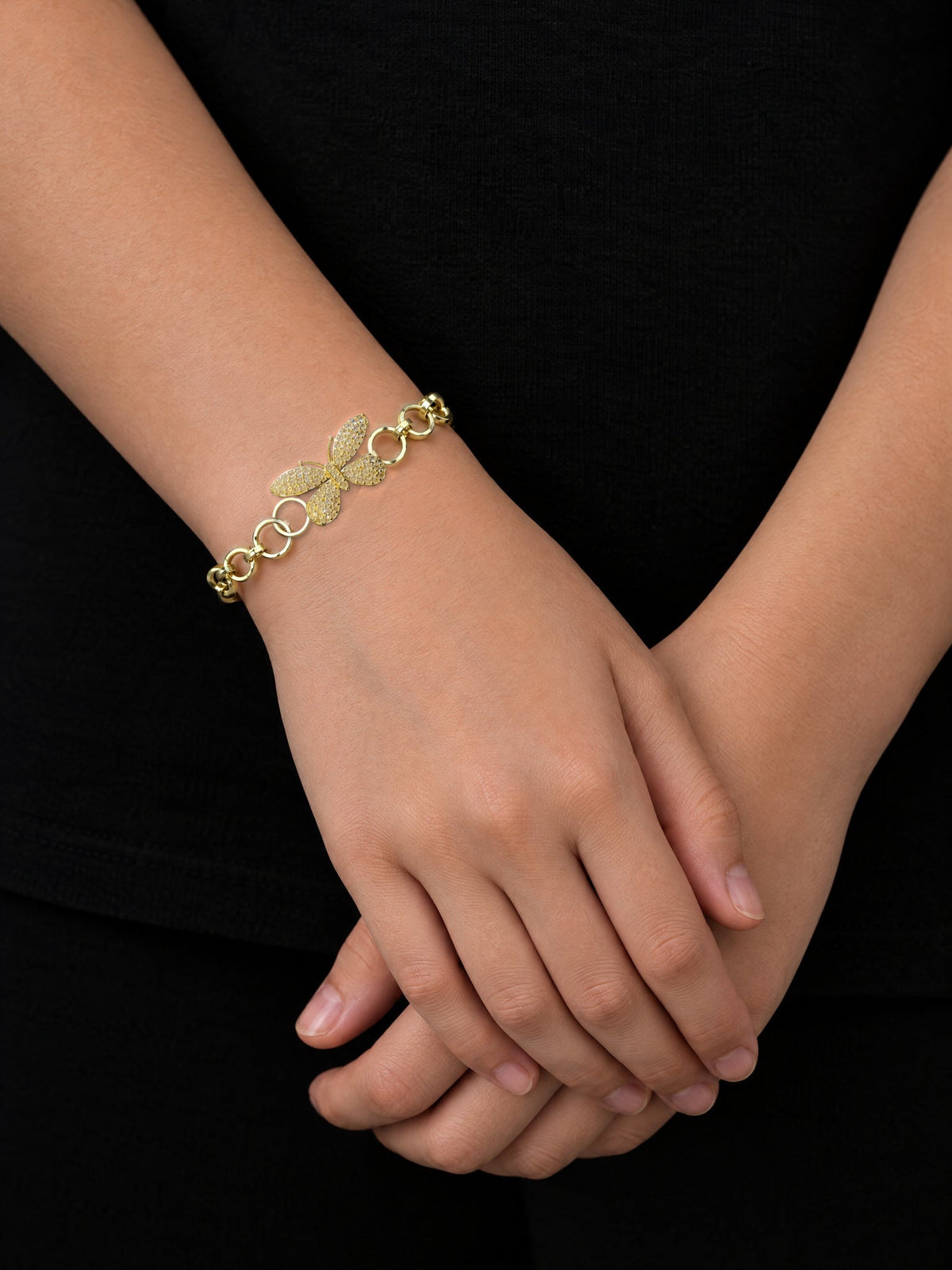 Girl with hands folded wearing the Girls Diamond Butterfly Charm Belcher Bracelet Gold Filled