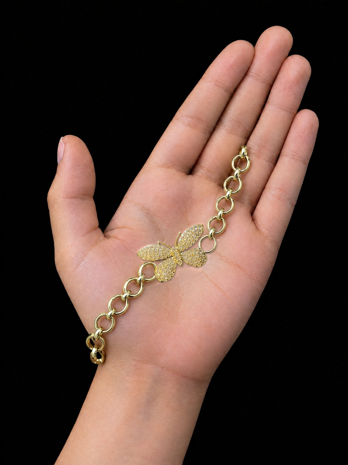 Girls Diamond Butterfly Charm Belcher Bracelet Gold Filled shown across a child's palm for size