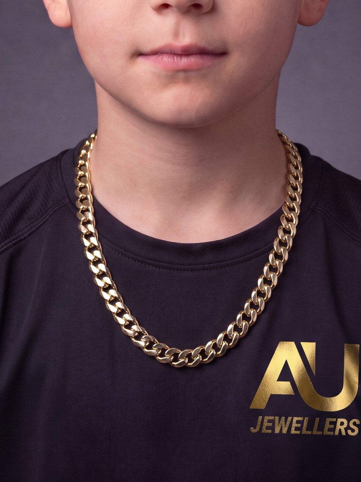 Kids 9ct Gold Filled Cuban Chain 10mm worn on model, close-up