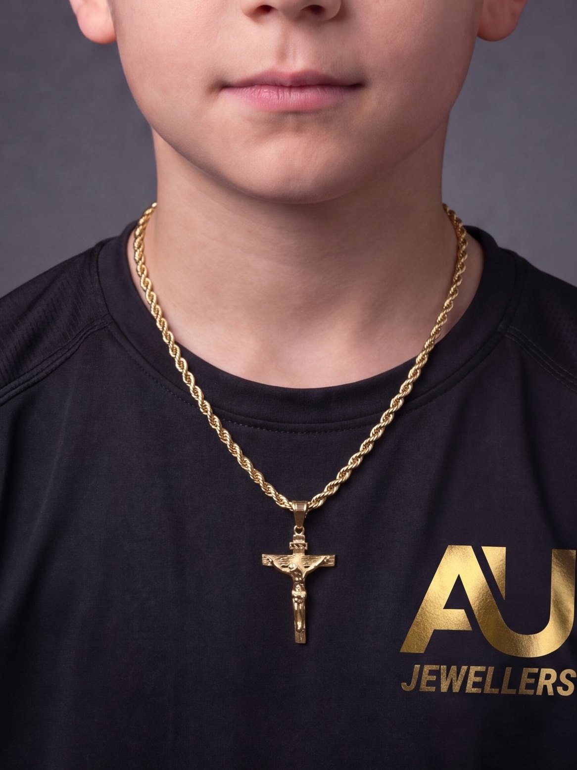 Kids Gold Filled Crucifix Pendant on a 6mm Rope Chain worn on model, close-up